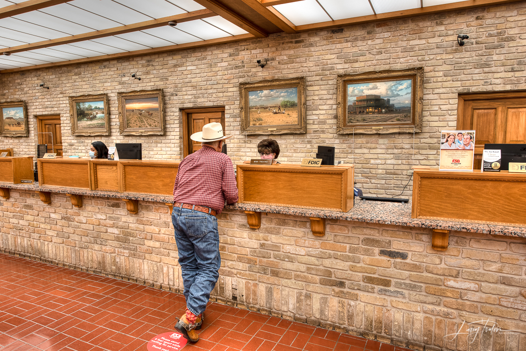 A customer at the teller line inside First State Bank of Uvalde