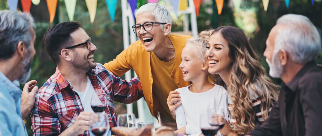 Family laughing together at an outdoor gathering
