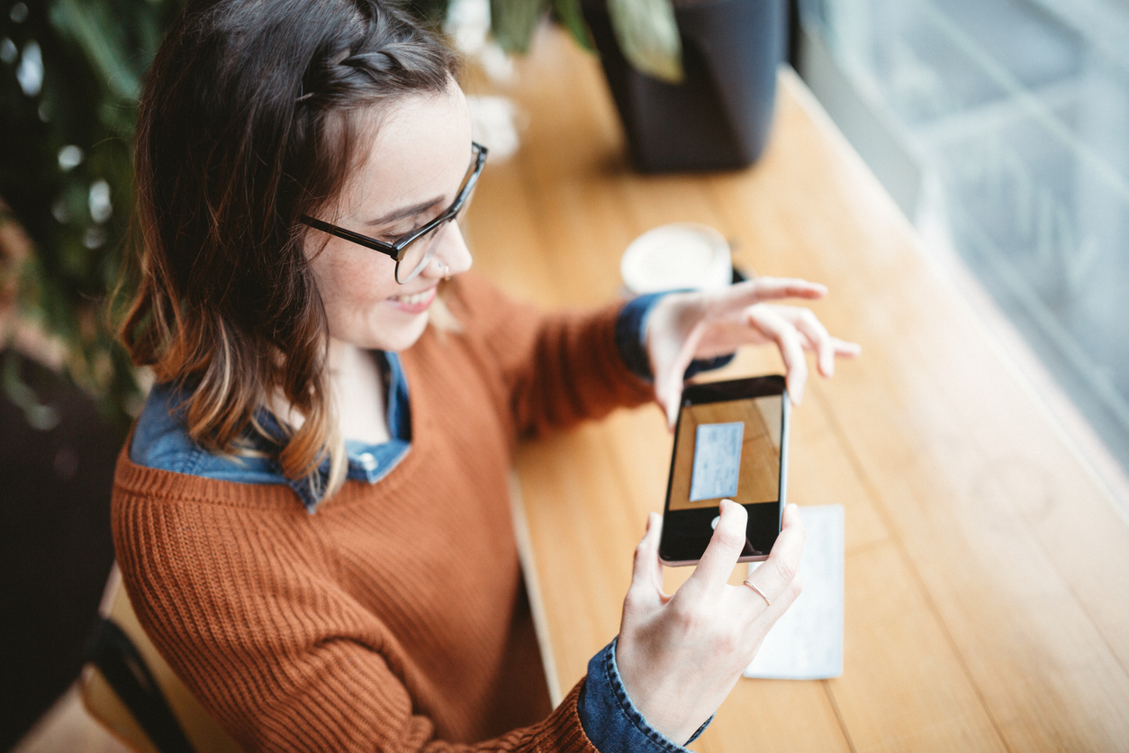 A member depositing a check with her phone